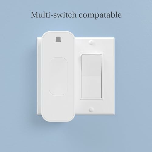 Multi-switch compatible white light switch on blue wall.