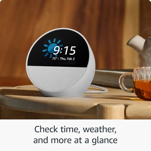 Smart clock showing time, weather, and date on a table.