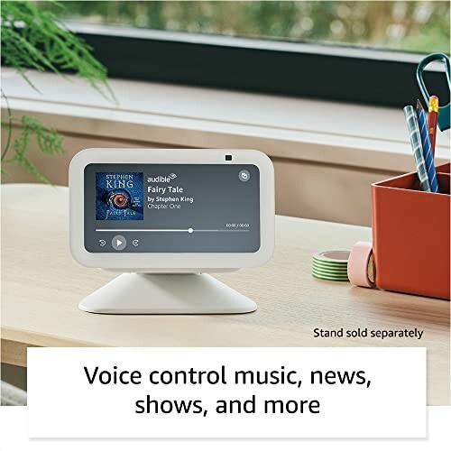 Smart display playing an audiobook on a desk.