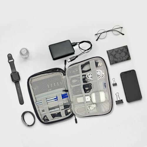 Flatlay of tech accessories and organizer kit with gadgets and cables.